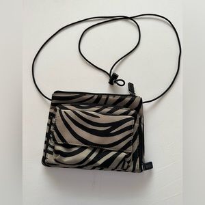 Adorable tan and black animal print clutch.